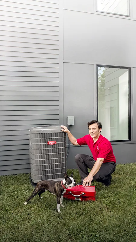 HVAC Technician beside outside AC unit with dog and toolbox | Bennett Heating and Air LLC