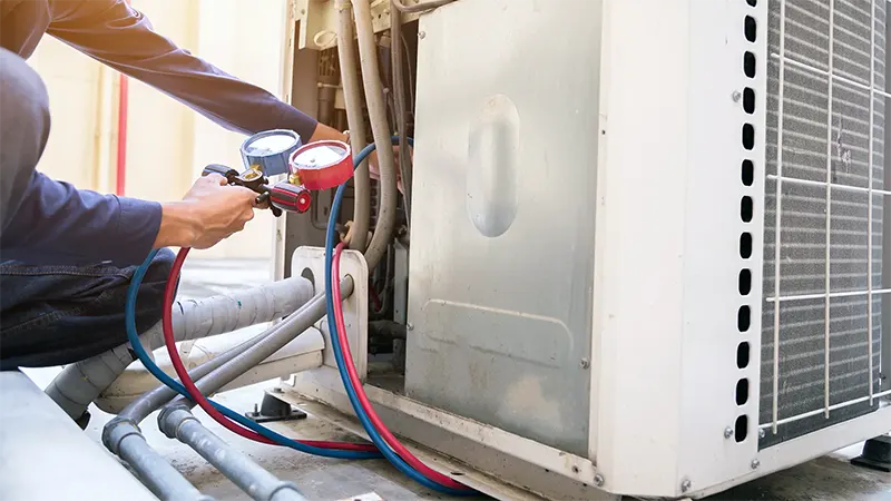 Close up of a HVAC Technician checking equipment with a HVAC Gauge | Bennett Heating and Air