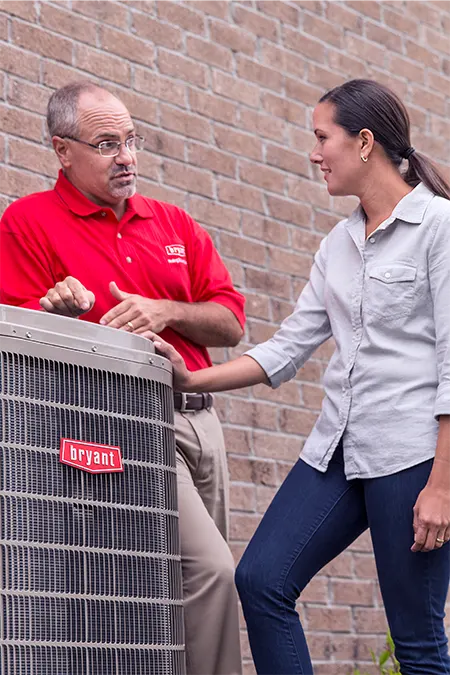 Bryant talking to home owner about outdoor ac unit | FAQ | Bennett Heating and Air LLC